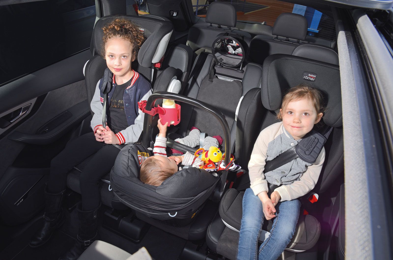 Rear seat with three child seats in it